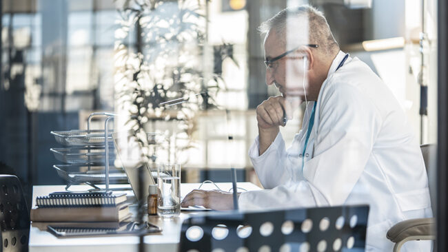 Doctor using laptop computer in the medical clinic