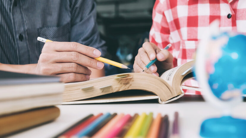 Young woman and man studying for a test or an exam.  Study group.