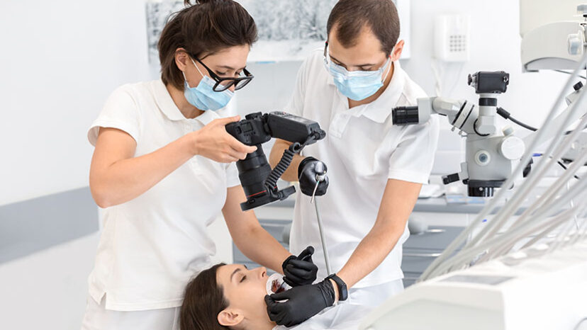 Professional dentist taking photo of patient teeth