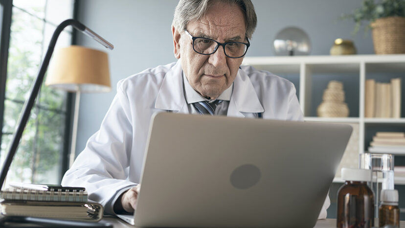 Doctor using laptop computer in the medical clinic