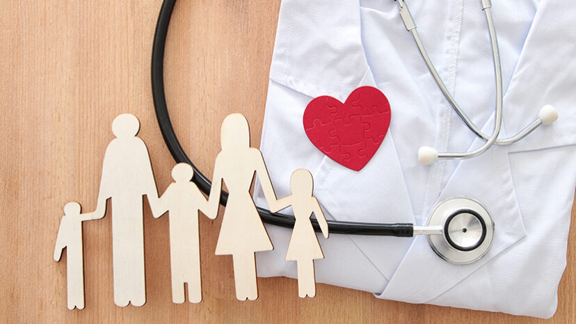 Health Insurance . concept image of Stethoscope and family on wooden table. top view