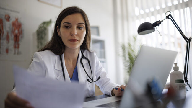 Female doctor working on laptop in the office
