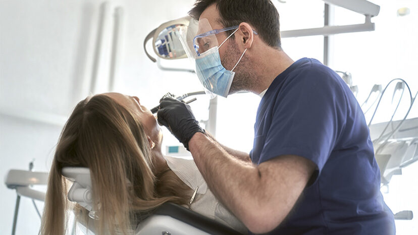Dentist drilling in teeth of the patient