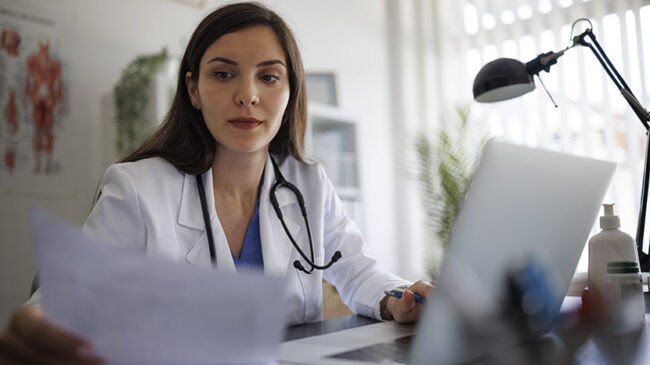 Female doctor working on laptop in the office